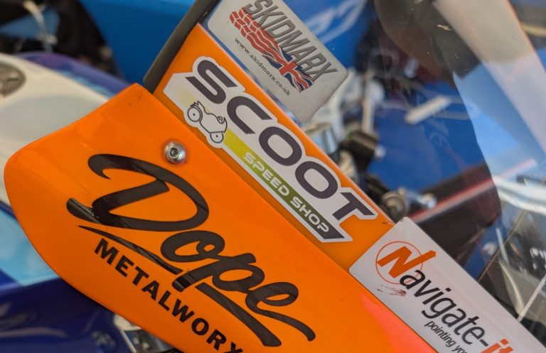 Close-up of a blue sports motorcycle's handlebars and fairing.