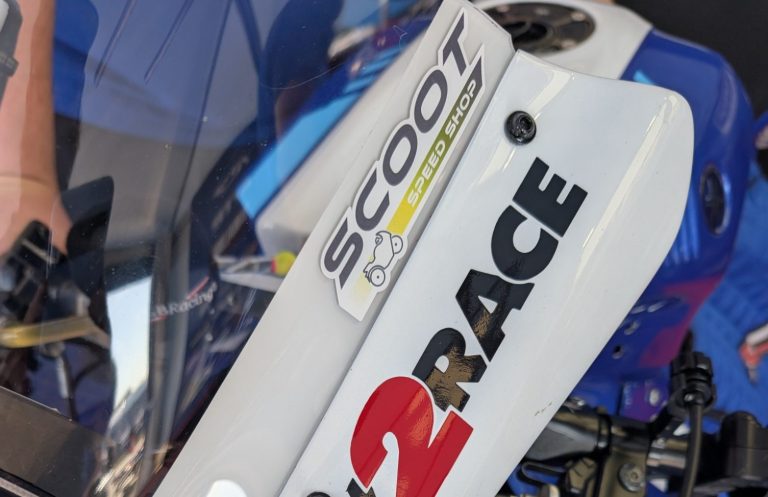 Close-up of a blue sports motorcycle's handlebars and fairing.